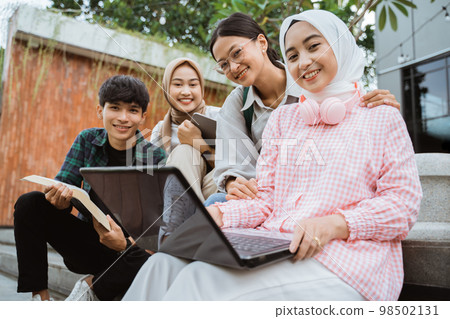 smiling young people working together on a laptop 98502131