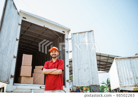 warehouse workers with arms crossed in front of containers warehouse workers with arms crossed in front of containers 98502263