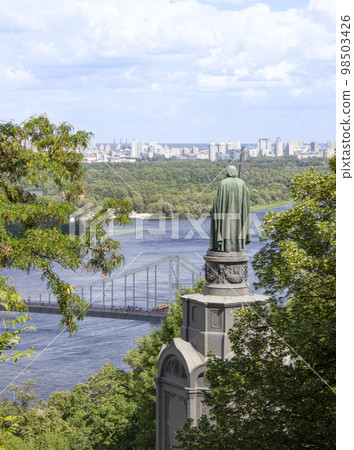 View of the monument of St Vladimir, in summer, with the Dnieper river and the city of Kyiv in background . Photo of spring Kiev, Vladimir Hill park. Ukraine. View of the monument of St Vladimir, in summer, with the Dnieper river and the city of Kyiv in background . Photo of spring Kiev, Vladimir Hill park. Ukraine. 98503426
