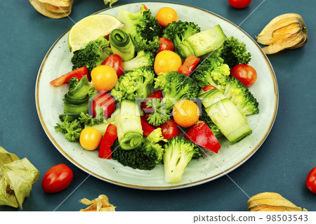 Spring raw salad decorated with physalis. Spring raw salad decorated with physalis. 98503543