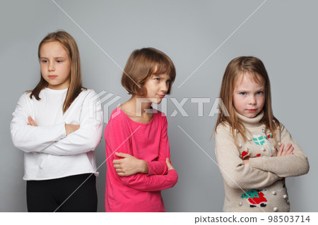 Offended displeased children friends with crossed arms. Young girls 8-10 years old portrait Offended displeased children friends with crossed arms. Young girls 8-10 years old portrait 98503714