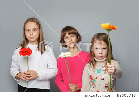 Three funny children with flowers, portrait 98503718
