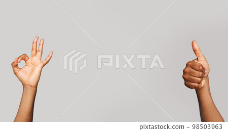 Gesture. Hands showing okay sign and thumb up gesture on gray banner background 98503963