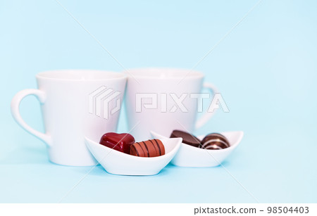 Boxed chocolates, coffee and a pair of mugs [Valentine's image] 98504403