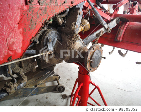 Tractor with rear wheels removed for tire replacement Tractor with rear wheels removed for tire replacement 98505352