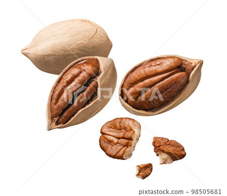 Whole pecan nuts and pieces flying isolated on white background 98505681