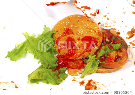Broken hamburger against the background of splashed ketchup.Creative hamburger. 98505864
