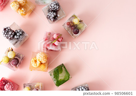 Frozen ice cubes with various berries Frozen ice cubes with various berries 98506601