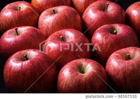 many apples on black background 98507310
