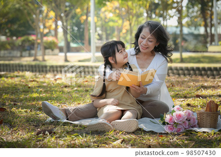 Asian Grandmother and Granddaughter having activity together outdoor park. Hobbies and leisure, lifestyle, family life, happiness moment concept Asian Grandmother and Granddaughter having activity together outdoor park. Hobbies and leisure, lifestyle, family life, happiness moment concept 98507430