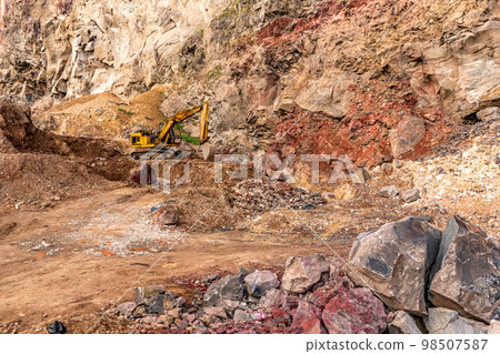 excavator at a quarry in the mountains 98507587