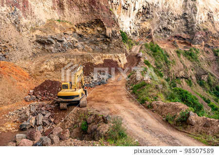 excavator at a quarry in the mountains 98507589