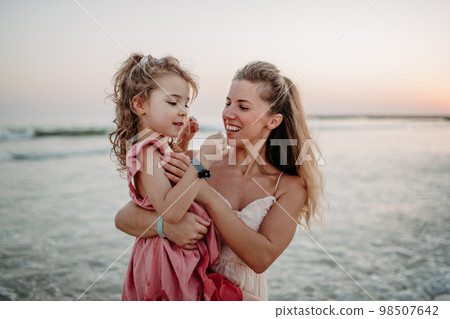 Mother enjoying together time with her daughter at sea. 98507642