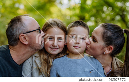 Portrait of happy family with kids in a forest. 98507772