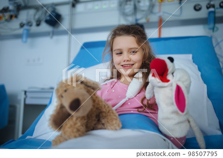 Portrait of little girl in hospital room with her toys. Portrait of little girl in hospital room with her toys. 98507795