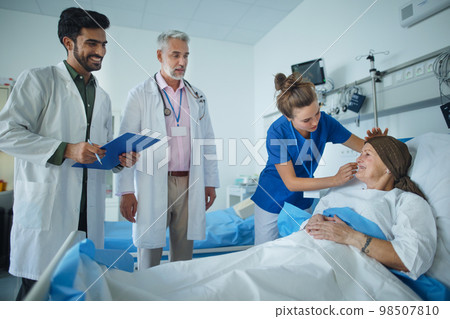 Senior woman lying in hospital room after chemotherapy. 98507810