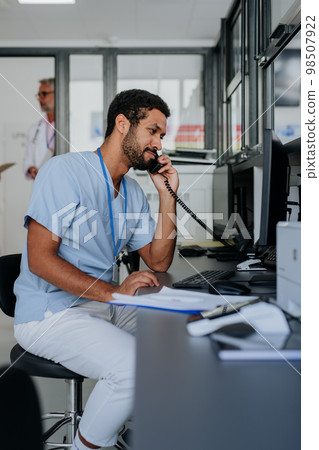 Portrait of young doctor working in his office. Portrait of young doctor working in his office. 98507922
