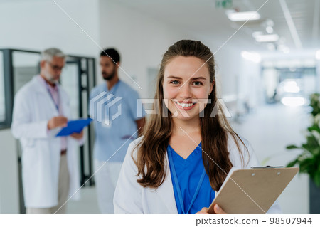 Portrait of young woman doctor at hospital corridor. 98507944