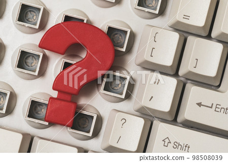 Close-up of a disassembled computer keyboard with a red question mark on it 98508039