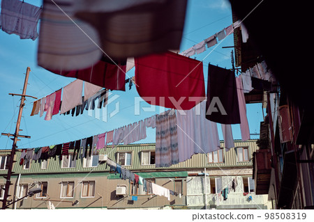 Ghetto life. Day shot of buildings with drying clothes at outdoor. 98508319
