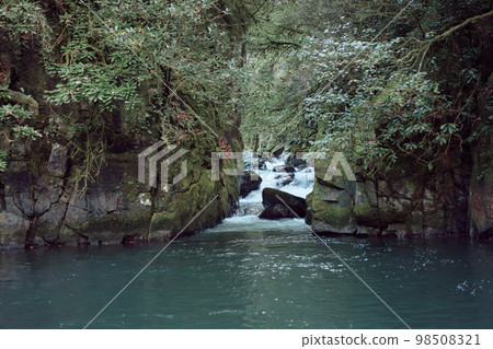 Small waterfall creek running into forest lake. Small waterfall creek running into forest lake. 98508321