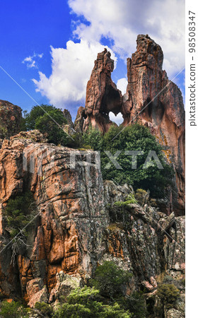 Amazing red rocks of Calanques de Piana. Rock with heart shape. Unique formations and national park of Corsica island, France Amazing red rocks of Calanques de Piana. Rock with heart shape. Unique formations and national park of Corsica island, France 98508347