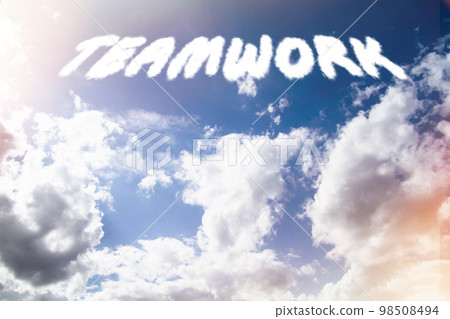 Teamwork. Text from clouds in sky in bright sunlight. Teamwork. Text from clouds in sky in bright sunlight. 98508494