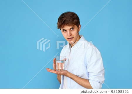 Young handsome man with drinking glass of water Young handsome man with drinking glass of water 98508561