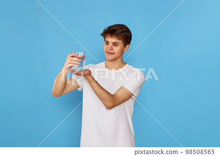 Young handsome man with drinking glass of water 98508565