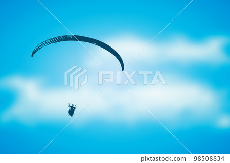 paragliding adventure paraglider in blue cloudy sky 98508834