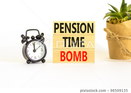 Pension time bomb symbol. Concept words Pension time bomb on wooden blocks on a beautiful white table white background. Black alarm clock. House plant. Business pension time bomb concept. Copy space. 98509135