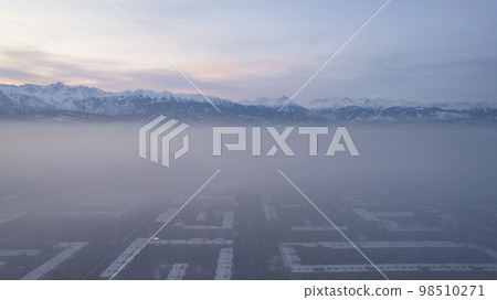 Dawn over the city in fog and smog. Mountain view Dawn over the city in fog and smog. Mountain view 98510271