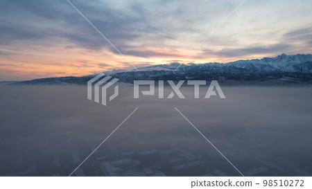 Dawn over the city in fog and smog. Mountain view 98510272