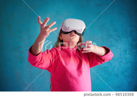 little girl playing with VR glasses little girl playing with VR glasses 98510308