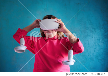 little girl playing with VR glasses little girl playing with VR glasses 98510314