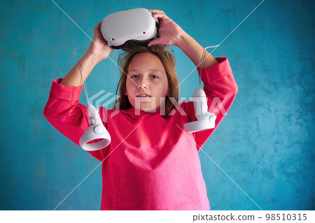 little girl playing with VR glasses little girl playing with VR glasses 98510315