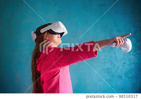 little girl playing with VR glasses little girl playing with VR glasses 98510317