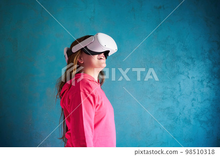 little girl playing with VR glasses 98510318