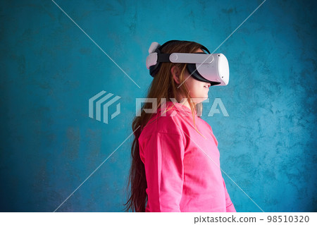 little girl playing with VR glasses 98510320