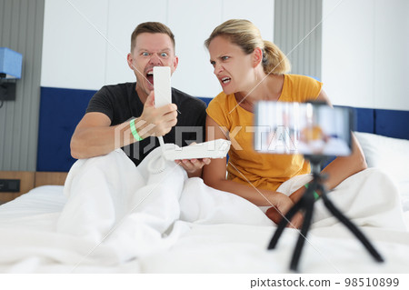 Angry couple of tourists call reception and complain to hotel staff about problems in room. 98510899