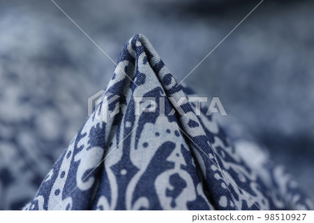 Blue fabric with white geometric ornament close up. Blue fabric with white geometric ornament close up. 98510927