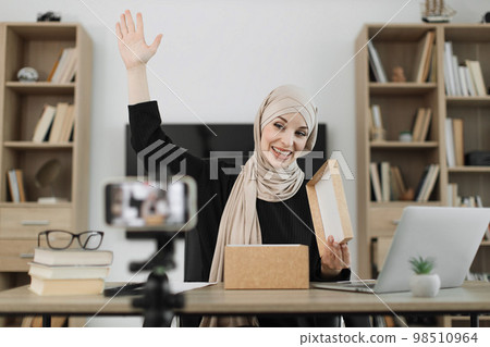 Arab woman using smart phone camera for creating content. Arab woman using smart phone camera for creating content. 98510964