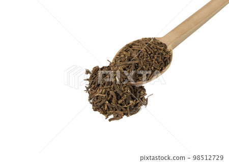 Valerian herb root on wooden spoon isolated on white background. Valeriana officinalis. used in herbal medicine as a tranquillizer and to treat insomnia, anxiety, hypertension, pain relief. 98512729