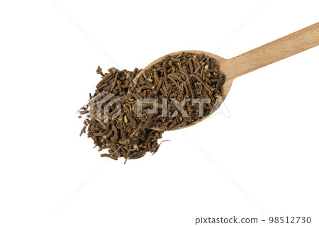 Valerian herb root on wooden spoon isolated on white background. Valeriana officinalis. used in herbal medicine as a tranquillizer and to treat insomnia, anxiety, hypertension, pain relief. 98512730