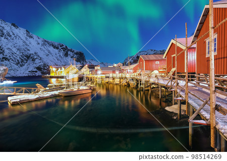 Fabulous evening seascape of Norwegian sea and cityscape of Nusfjord village with Northern Lights Fabulous evening seascape of Norwegian sea and cityscape of Nusfjord village with Northern Lights 98514269