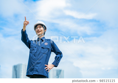 A young security guard guarding a skyscraper A young security guard guarding a skyscraper 98515115