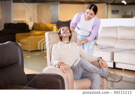 Happy couple choose a new armchair Happy couple choose a new armchair 98515215