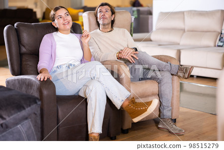 Happy couple choose a new armchair 98515279