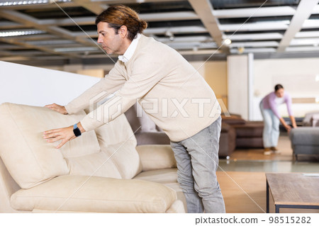 man checks the high quality of sofa 98515282