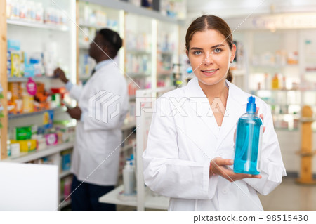 Pharmacist demonstrating haircare product 98515430